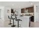 Eat-in kitchen features a stylish island with barstool seating, stainless steel appliances, and ample cabinetry at 8632 Sw 44Th Ter, Ocala, FL 34476