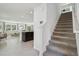 Inviting living space featuring a staircase, light tile flooring, and an open layout with modern accents at 8632 Sw 44Th Ter, Ocala, FL 34476