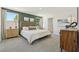 Airy main bedroom with two large windows, an accent wall, and a decorative wicker headboard at 8632 Sw 44Th Ter, Ocala, FL 34476