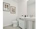 Neat half-bath with modern fixtures, pedestal sink, and decor at 8632 Sw 44Th Ter, Ocala, FL 34476