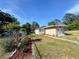 A house with a big, green backyard, complimented by landscaped accents at 910 Ne 11Th Ave, Ocala, FL 34470