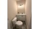 A well-lit, cozy bathroom features a toilet and white vanity at 910 Ne 11Th Ave, Ocala, FL 34470