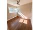 Cozy bedroom featuring hardwood floors, ceiling fan, and sunny bay windows at 910 Ne 11Th Ave, Ocala, FL 34470