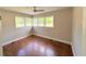 Bright bedroom with hardwood floors, neutral paint, and large windows providing ample natural light at 910 Ne 11Th Ave, Ocala, FL 34470