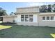 This home's exterior displays unique architecture, trimmed windows, and a lush green lawn at 910 Ne 11Th Ave, Ocala, FL 34470