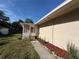 A home's side porch, complemented by manicured gardens, mulch, and green grass at 910 Ne 11Th Ave, Ocala, FL 34470