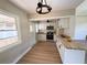 Bright updated kitchen featuring white cabinets, butcher block counters, and stainless steel appliances at 910 Ne 11Th Ave, Ocala, FL 34470