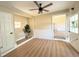 Bright living room featuring hardwood floors, ceiling fan, and lots of natural light at 910 Ne 11Th Ave, Ocala, FL 34470