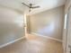 Living room features neutral paint, tile flooring, and a ceiling fan at 910 Ne 11Th Ave, Ocala, FL 34470