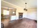 Open-concept living room featuring a stone fireplace and a kitchen with butcher block countertops at 910 Ne 11Th Ave, Ocala, FL 34470