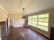 Spacious living room featuring large windows, a stone fireplace, and neutral paint at 910 Ne 11Th Ave, Ocala, FL 34470