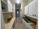 Bright pantry features ample storage space, counter, and white cabinets at 910 Ne 11Th Ave, Ocala, FL 34470