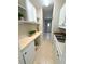 Bright pantry features ample storage space, counter, and white cabinets at 910 Ne 11Th Ave, Ocala, FL 34470