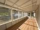Covered porch offers an outdoor living space with new flooring and fresh paint at 910 Ne 11Th Ave, Ocala, FL 34470