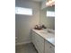 Bathroom featuring a bright vanity with modern hardware, a large mirror, and tile floors at 9326 Sw 57Th Ter, Ocala, FL 34476
