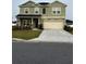 Two-story home featuring a two-car garage, neutral color palette, and well-maintained landscaping at 9326 Sw 57Th Ter, Ocala, FL 34476