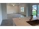 Kitchen view showcasing a center island with sink, white cabinets, and tile flooring at 9326 Sw 57Th Ter, Ocala, FL 34476