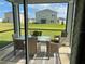 A screened porch has a glass table and four seats at 9326 Sw 57Th Ter, Ocala, FL 34476
