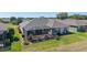 An aerial view shows the screened-in lanai, well-kept lawn, and landscaped grounds of the residence at 9443 Sw 71St Loop, Ocala, FL 34481