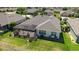 Aerial view showcases the home's screened-in lanai, lush landscaping, and well-maintained backyard at 9443 Sw 71St Loop, Ocala, FL 34481