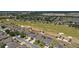 Picturesque aerial of homes bordering a golf course, complemented by lakes and mature landscaping at 9443 Sw 71St Loop, Ocala, FL 34481