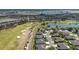 Panoramic aerial view of a community with lake and golf course views, showcasing a vibrant and active lifestyle at 9443 Sw 71St Loop, Ocala, FL 34481