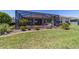 Landscaped backyard features lush grass, a screened-in lanai, and mature plantings at 9443 Sw 71St Loop, Ocala, FL 34481