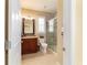 Cozy bathroom with shower stall, granite countertop, and wood cabinets at 9443 Sw 71St Loop, Ocala, FL 34481