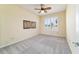 A well-lit bedroom features a window, art pieces, and a ceiling fan at 9443 Sw 71St Loop, Ocala, FL 34481