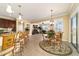 Bright dining area adjacent to kitchen and living room, featuring tropical themed decor and easy access to outdoor patio at 9443 Sw 71St Loop, Ocala, FL 34481