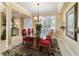 Elegant dining room with tile floors, shutters, chandelier, and open layout into the living room at 9443 Sw 71St Loop, Ocala, FL 34481