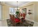 Beautiful dining area with chandelier lighting, plantation shutters and a glass-top table at 9443 Sw 71St Loop, Ocala, FL 34481