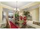 Open dining area with glass table, chandelier, and views to the living room at 9443 Sw 71St Loop, Ocala, FL 34481