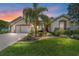 Beautifully landscaped front yard with a charming home featuring a well-maintained lawn and a welcoming red front door at 9443 Sw 71St Loop, Ocala, FL 34481