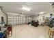 Spacious two car garage with bright lighting, providing ample parking and storage space at 9443 Sw 71St Loop, Ocala, FL 34481