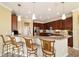 Elegant kitchen featuring wood cabinetry, stainless steel appliances, and a breakfast bar at 9443 Sw 71St Loop, Ocala, FL 34481