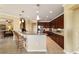Gourmet kitchen with breakfast bar, stainless steel appliances, and modern pendant lighting at 9443 Sw 71St Loop, Ocala, FL 34481