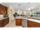 Bright kitchen featuring wood cabinets, stainless steel appliances, and views to the living room at 9443 Sw 71St Loop, Ocala, FL 34481