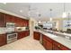 Bright kitchen featuring wood cabinets, stainless steel appliances, and an open floorplan at 9443 Sw 71St Loop, Ocala, FL 34481