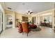 Open living room featuring tile floors, a ceiling fan, and views into the dining room, creating an airy atmosphere at 9443 Sw 71St Loop, Ocala, FL 34481