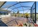 The screened-in patio showcases a fountain and lush landscaping, providing a serene outdoor living space at 9443 Sw 71St Loop, Ocala, FL 34481