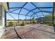 Large screened-in lanai with decorative concrete flooring, water fountain, and ample space for outdoor seating at 9443 Sw 71St Loop, Ocala, FL 34481
