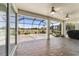 Expansive screened patio features ceiling fans, decorative concrete floors, and golf course views at 9443 Sw 71St Loop, Ocala, FL 34481