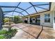 View of screened patio with water feature, ceiling fans and golf course views beyond at 9443 Sw 71St Loop, Ocala, FL 34481