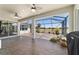 Large screened patio features ceiling fans and golf course views, perfect for outdoor living at 9443 Sw 71St Loop, Ocala, FL 34481