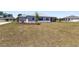 Expansive backyard featuring a spacious lawn and a screened-in lanai for outdoor relaxation and entertaining at 9973 Sw 107Th Ter, Ocala, FL 34481