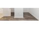 Unfinished basement area with wood-look floors and white baseboards at 9973 Sw 107Th Ter, Ocala, FL 34481