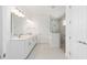Bathroom features double sinks, tiled floors and a tiled shower at 9973 Sw 107Th Ter, Ocala, FL 34481