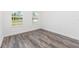 Bright bedroom with two windows, complemented by stylish wood flooring, offers a serene and inviting atmosphere at 9973 Sw 107Th Ter, Ocala, FL 34481