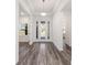 Inviting foyer boasting tray ceiling, hardwood floors, and glass-paneled front door with sidelights at 9973 Sw 107Th Ter, Ocala, FL 34481